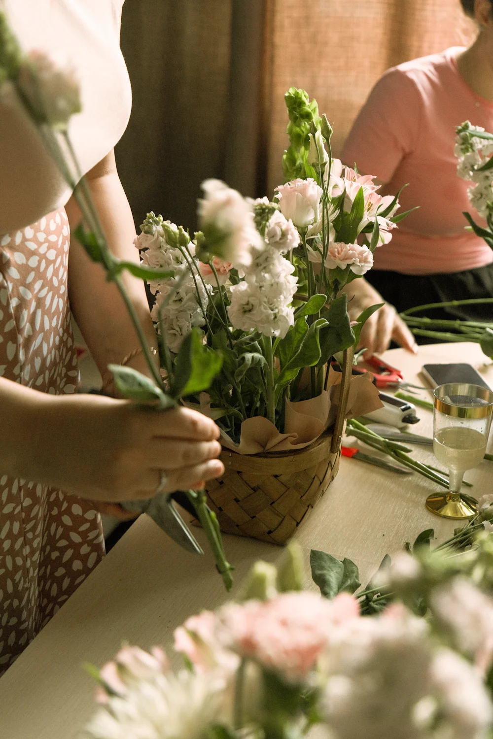 Ruth building a hand-tied bouquet of white and green flowers
