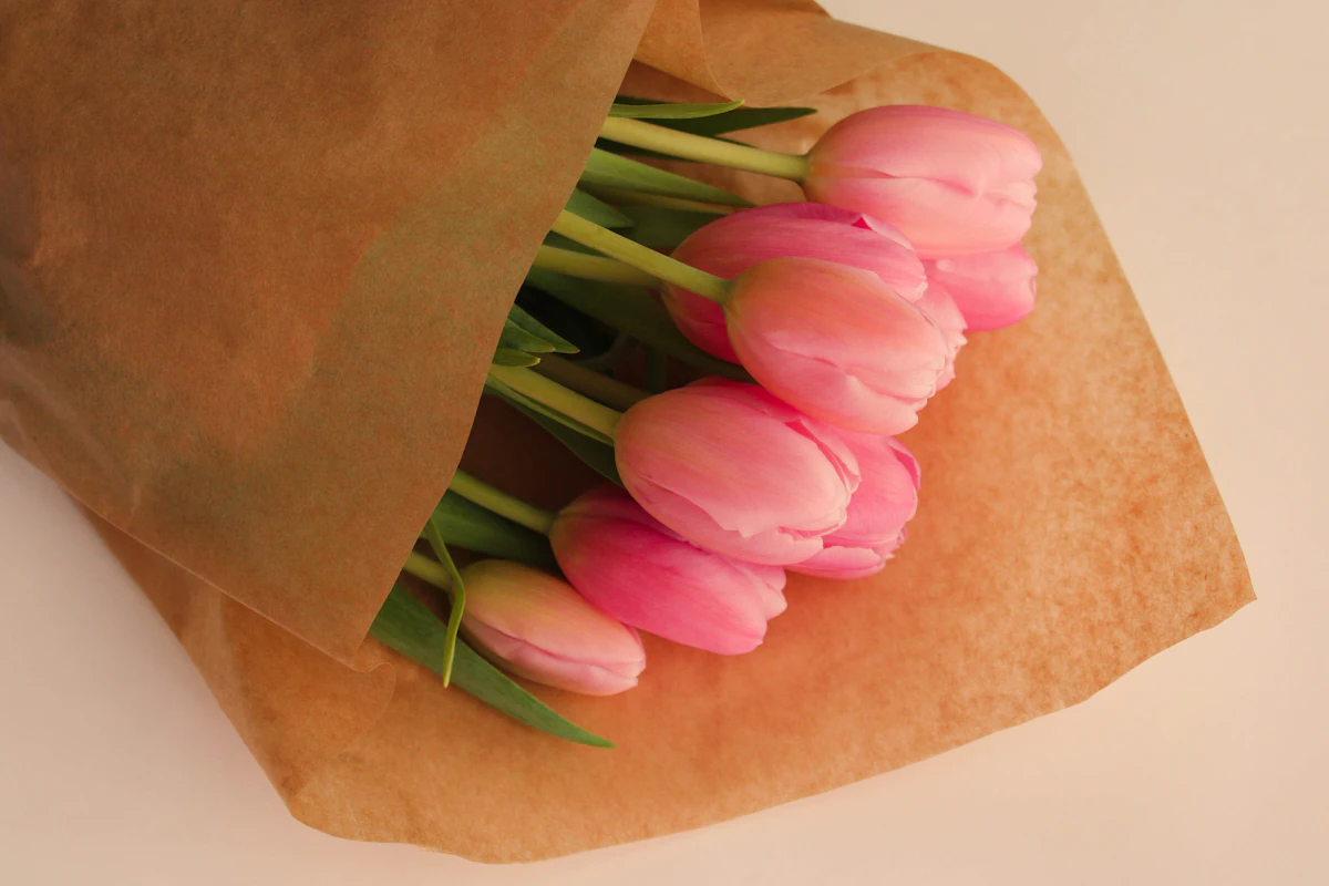 Pink tulips wrapped in brown paper